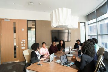 A group of people meeting around a table in a conference room