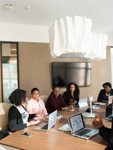 A group of people meeting around a table in a conference room