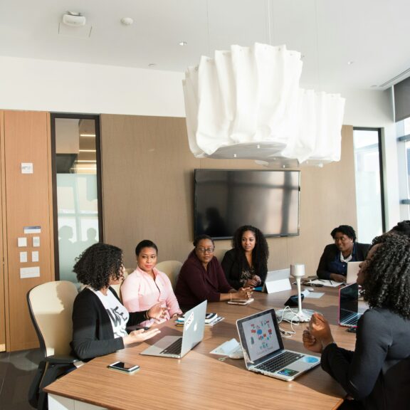 A group of people meeting around a table in a conference room