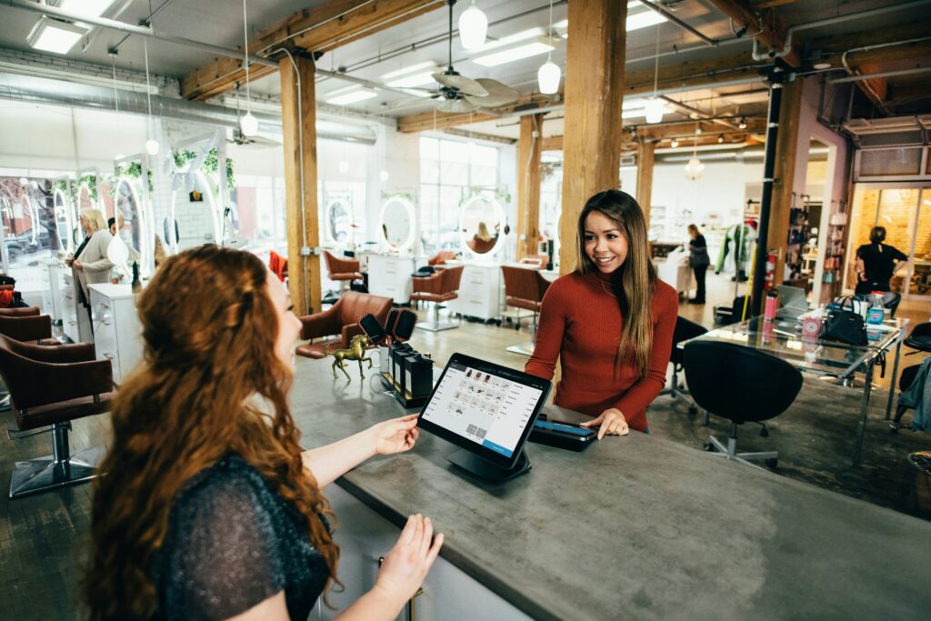 Two people sitting across one another with tablets